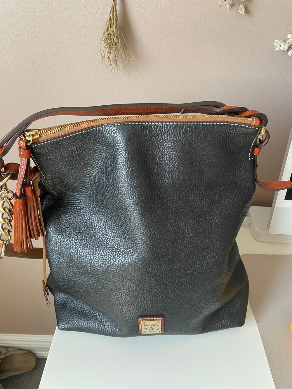 Dooney & Bourke Black Pebbled Leather Shoulder Bag with Brown Trim and Tassel